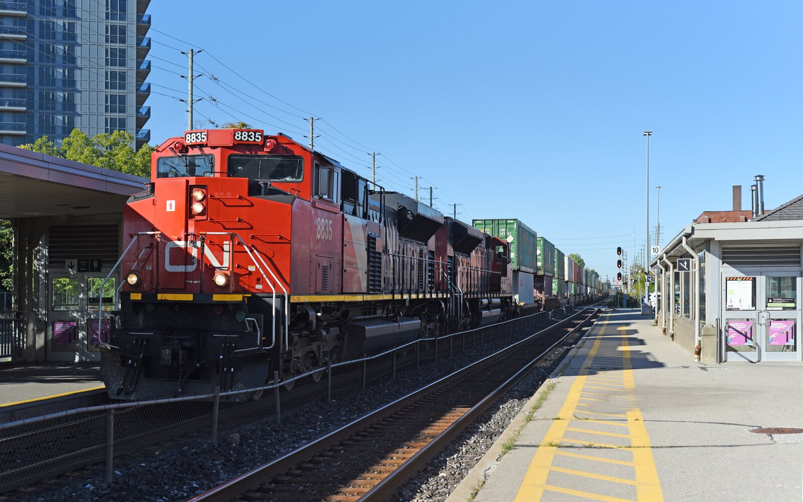 CN container train led by locomotive 8835 at a Brampton GO station