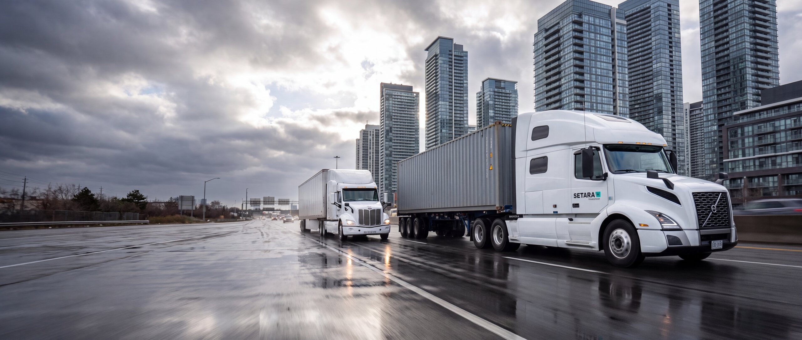 Setara Transport trucks on a Toronto highway: a container truck and a dry van truckload, with the downtown towers behind